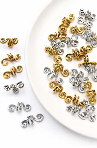 Detail von spiralförmigen Legierungs-Haaranhängern mit Punktmuster in Gold und Silber