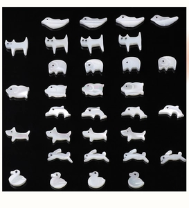 Macro detail of diverse animal-shaped natural shell charms for DIY jewelry making