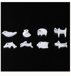 Detailed view of eight natural shell animal charms for handmade jewelry DIY projects
