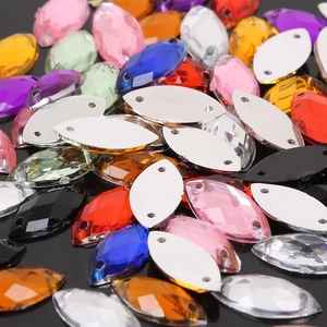 Macro shot of multi-color horse-eye acrylic rhinestones with double holes for sewing DIY