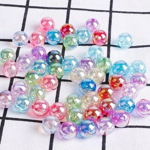 Colorful AB coated acrylic beads for DIY jewelry making scattered on grid background