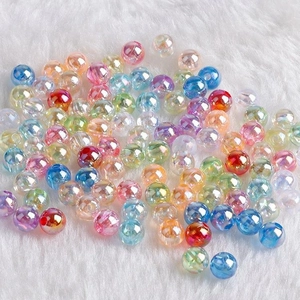 Macro shot of colorful AB coated faceted acrylic beads on white faux fur background