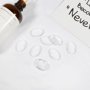 Set of clear glass cabochons for DIY jewelry making on a minimalist white background