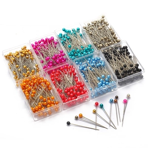 Eight colors of pearlized head pins in storage boxes for DIY jewelry making and crafts