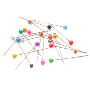 Assorted colorful pearl head pins for sewing and jewelry making on white background