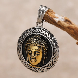 Macro detail of Buddha pendant featuring golden relief and textured silver frame