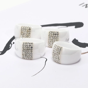 Minimalist white ceramic ring with five rows of sparkling diamonds in a modern wide band design