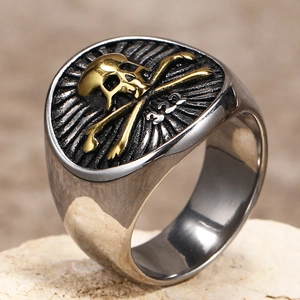 Macro shot of two-tone punk skull signet ring with gold crossbones and 322 engraving