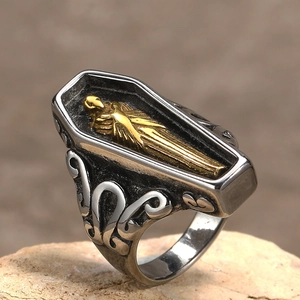 Macro view of gothic coffin ring with golden relief and ornate vintage engravings