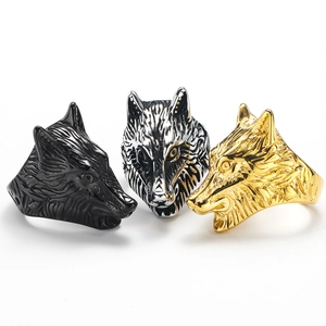 Detailed view of wolf head rings in black, silver and gold finish with textured fur details