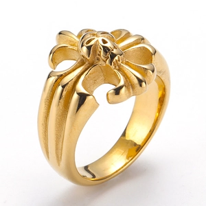 Macro shot of gold punk ring featuring intricate skull and cross relief engravings