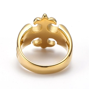 Detailed view of the hollow fleur-de-lis and cross design on a gold polished ring