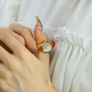 Elegant gold titanium steel ring featuring a large round cat-eye stone for women