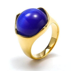 Macro view of gold plated wide ring band with large blue cat-eye stone inlay