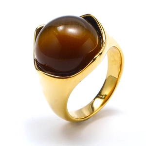 Detailed close-up of a vintage gold titanium ring featuring a brown cat eye stone inlay