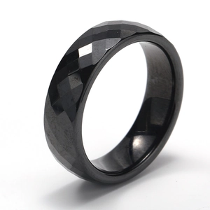 Macro shot of the black bio-ceramic ring showing multifaceted diamond cut geometric design