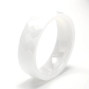 Detail view of white bioceramic ring featuring modern geometric faceted surface design