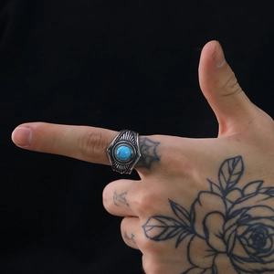 Detalle de anillo de acero para hombre estilo punk vintage con piedra azulada