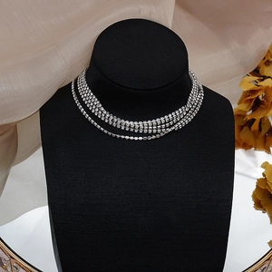 Detail of five-row silver rhinestone choker necklace on black velvet mannequin