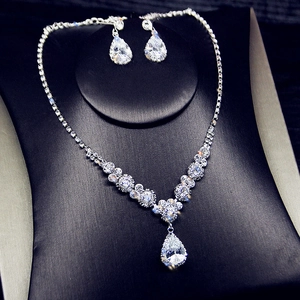 Detail of silver bridal jewelry set featuring pear-cut crystals on a black necklace bust