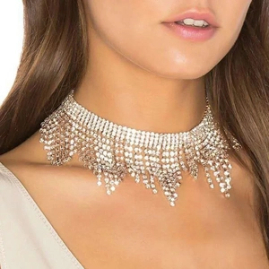 Macro detail of silver rhinestone choker showing multi-layer tassel fringe and sparkling crystals