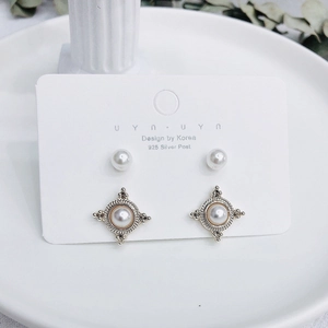 Dettaglio del set di orecchini in argento 925 con perle e design vintage a stella