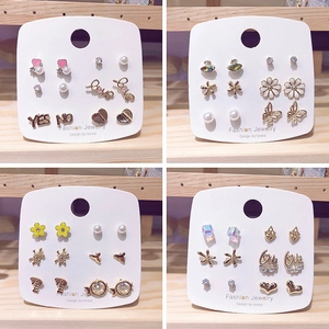 Detail view of 6 pairs of assorted studs featuring hearts, pearls and butterfly motifs