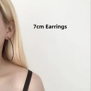 Detailed macro view showing the wearing effect of a 7cm large black hoop earring