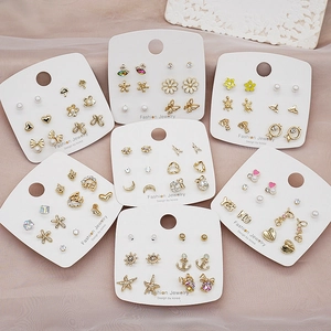 Flat lay of diverse 925 silver needle stud earring sets on elegant white cards