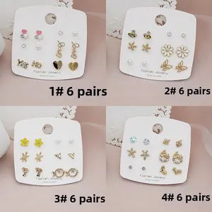 Close-up of 925 silver needle earring sets with pearls and crystals on display cards