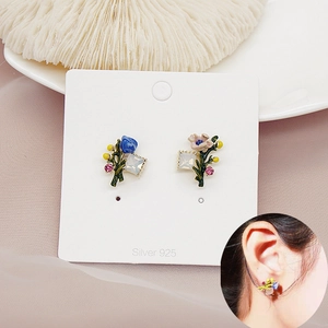 Detailed view of asymmetric enamel flower earrings with S925 silver needles and crystal