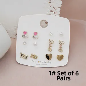 Detailed view of 6 pairs set 925 silver needle stud earrings on white card display