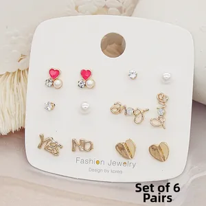 Detailed view of a 6-pair gold stud earring set with hearts, pearls and love letters