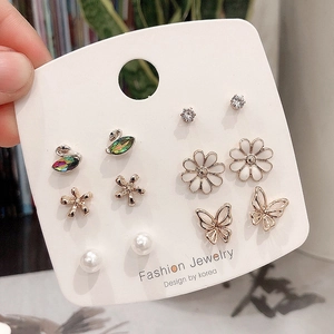 Set of six assorted gold-plated earrings featuring swan, flower, and butterfly motifs