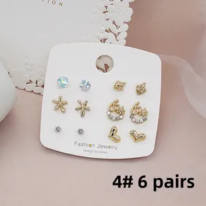 Detail of 6 pairs set of 925 silver needle gold earrings with crystals and heart shapes