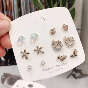 Detailed view of a 6-pair gold earring set with heart, crown, and rhinestone designs