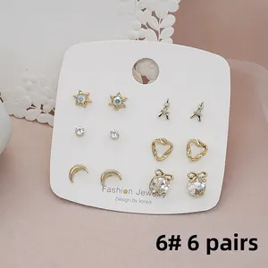 Detail view of 6-pair gold stud earrings set featuring star and moon motifs on a card