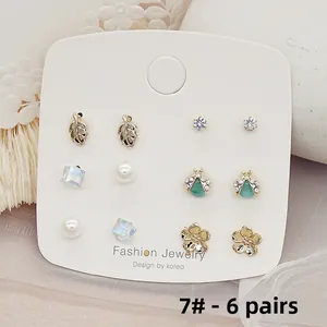 Exquisite 6-pair gold plated earring set with pearls and floral designs on display card