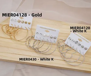 Detail view of gold and silver C-shaped hoop earring sets on display cards