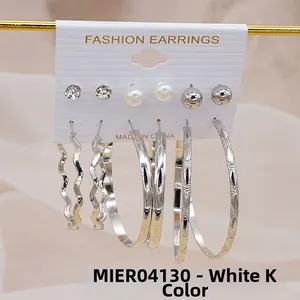 Set of six pairs of silver-colored earrings featuring crystal studs and large C-shape hoops