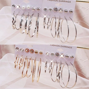 Golden and silver hoop earring set with pearls and rhinestones on a fashion display card