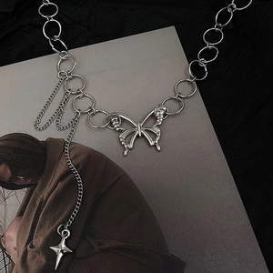 Detail of silver butterfly pendant necklace with ring chain and dangling star charm