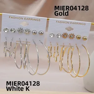 Detail of 6-pair gold and silver hoop earring set with heart and star charms