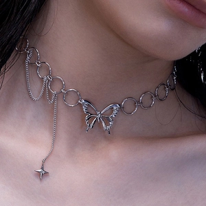 Silver butterfly choker with star charm and tassel chain detail on female model