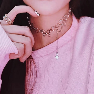 Close-up of butterfly pendant choker with star chain and matching link ring set