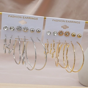 Set of 12 pairs of gold and silver fashion earrings with hoop and heart designs