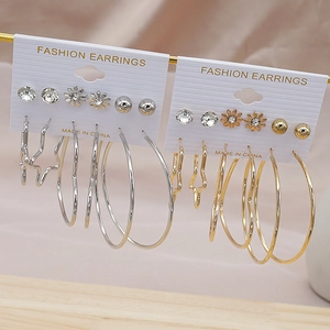 Detail view of 6 pairs of gold and silver hoop earring sets with hearts and stars