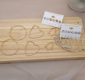 Detail of 6-pair gold and silver mixed earring set with hoop, heart, and star designs