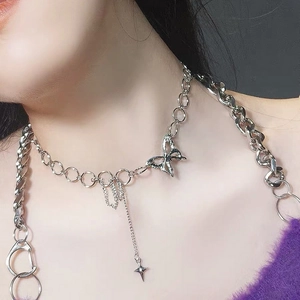 Silver butterfly choker necklace with mixed Cuban and ring links worn by a model