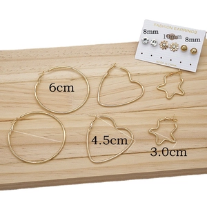 Chunky gold-plated hoop set with round, heart, and star shapes plus stud earrings
